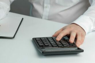 a-man-calculating-income-and-expenses-2022-11-16-19-19-31